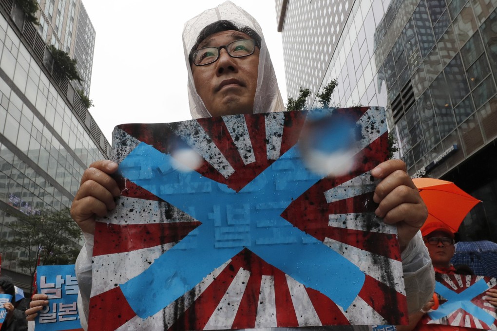 South Korean protesters hold Japanese rising sun flags during a rally to mark the South Korean Liberation Day from Japanese colonial rule. Photo: AP