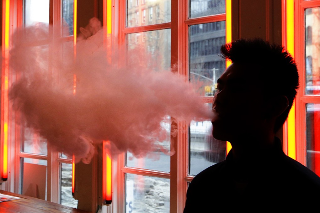 A patron exhales vapour from an e-cigarette at a store in New York. Photo: AP