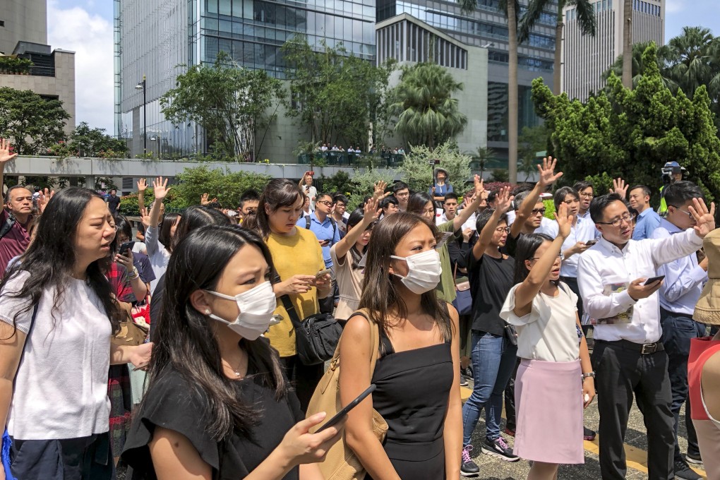 Office workers singing Glory to Hong Kong and chanting protest slogans at Chater Garden in Central on Friday afternoon. Photo: Gigi Choy