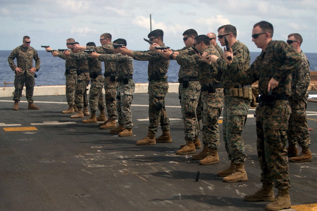 US Marines practise speed reloads on August 9 aboard the USS Green Bay, part of the Wasp Amphibious Ready Group, in the Indo-Pacific region. Photo: Handout