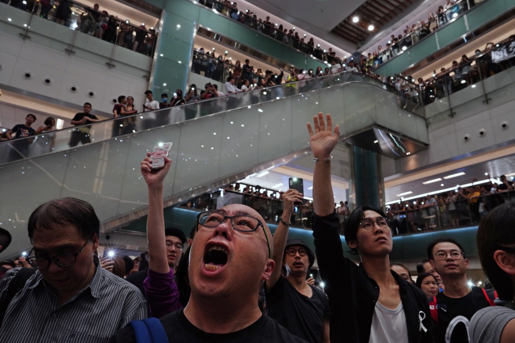 Protesters sing the movement’s newest theme song, Glory to Hong Kong, at a mall in Hong Kong on September 11. The protests have hurt Hong Kong’s economy, and the first to suffer will be those working in restaurants and the retail and the hospitality trades. Photo: AP