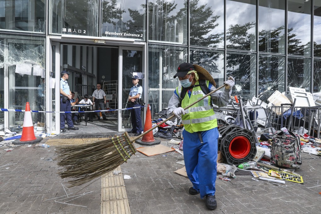 A worker begins the process of cleaning up after the Legislative Council complex was vandalised during an anti-government protest on July 1. Photo: Nora Tam
