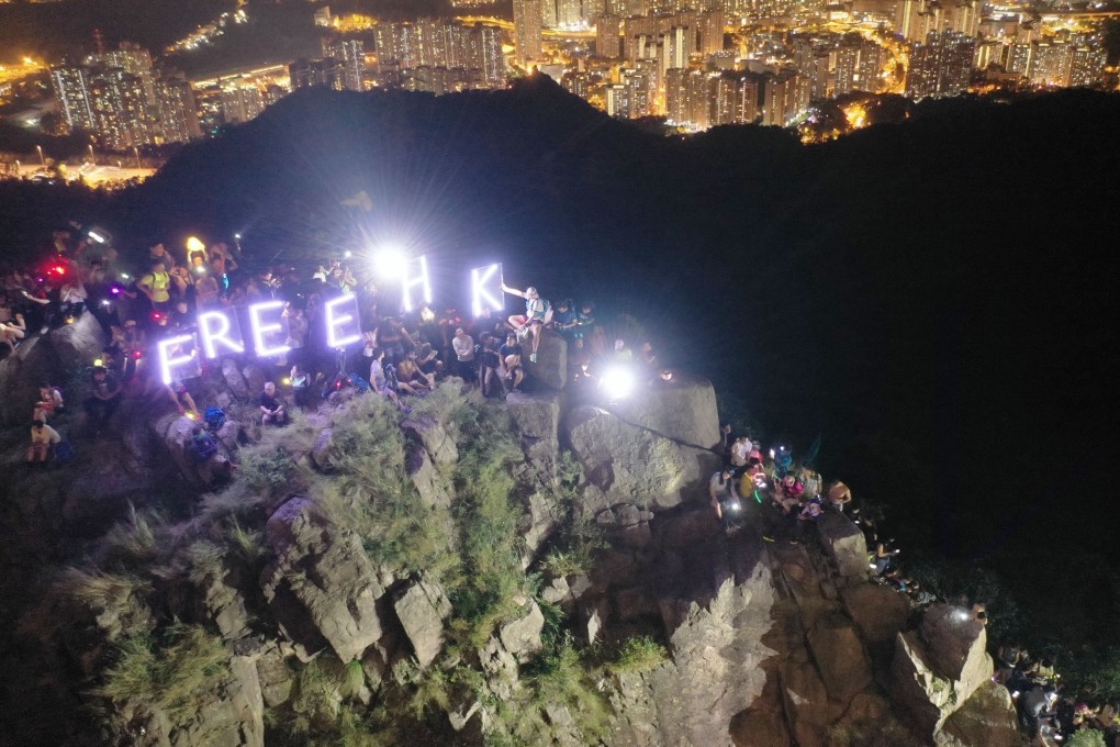 Hikers forms a human chain on Lion Rock, in protest against the extradition bill. Photo: Martin Chan