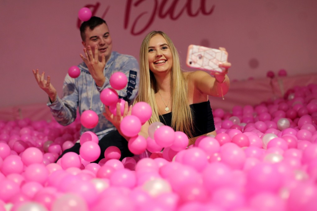 Visitors take selfies at the Selfie Factory in Westfield London shopping centre in west London. Photo: AFP