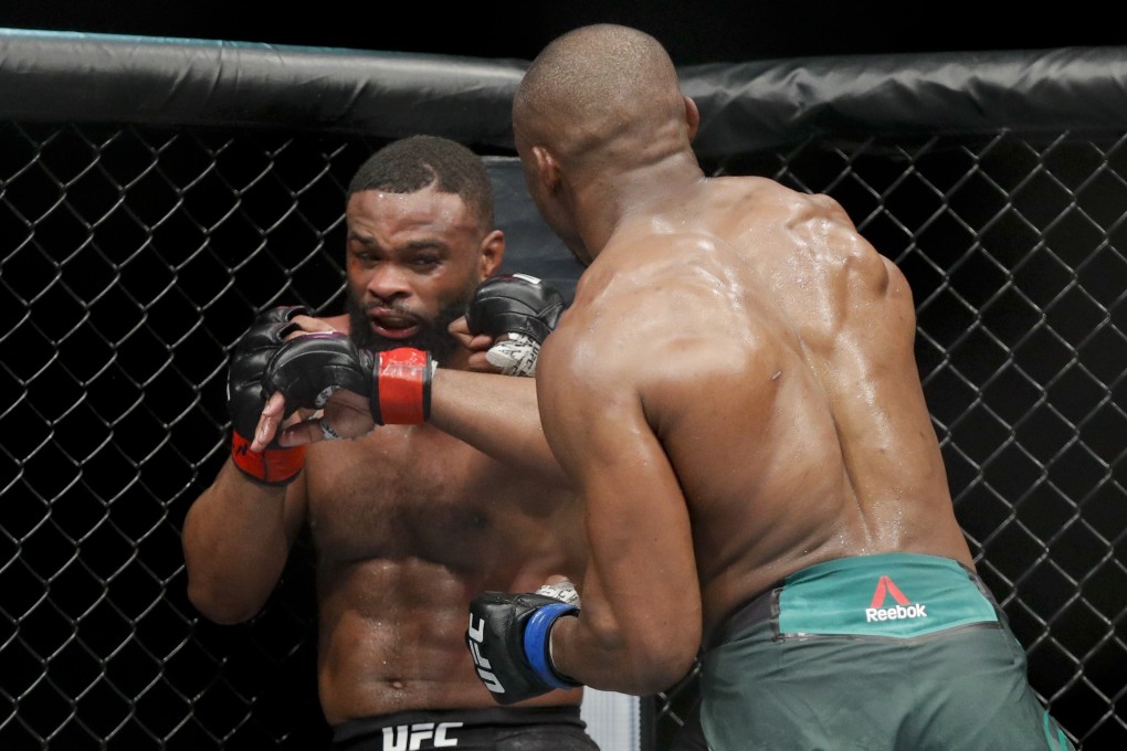 Kamaru Usman (right) hits Tyron Woodley at UFC 235. Photo: AP