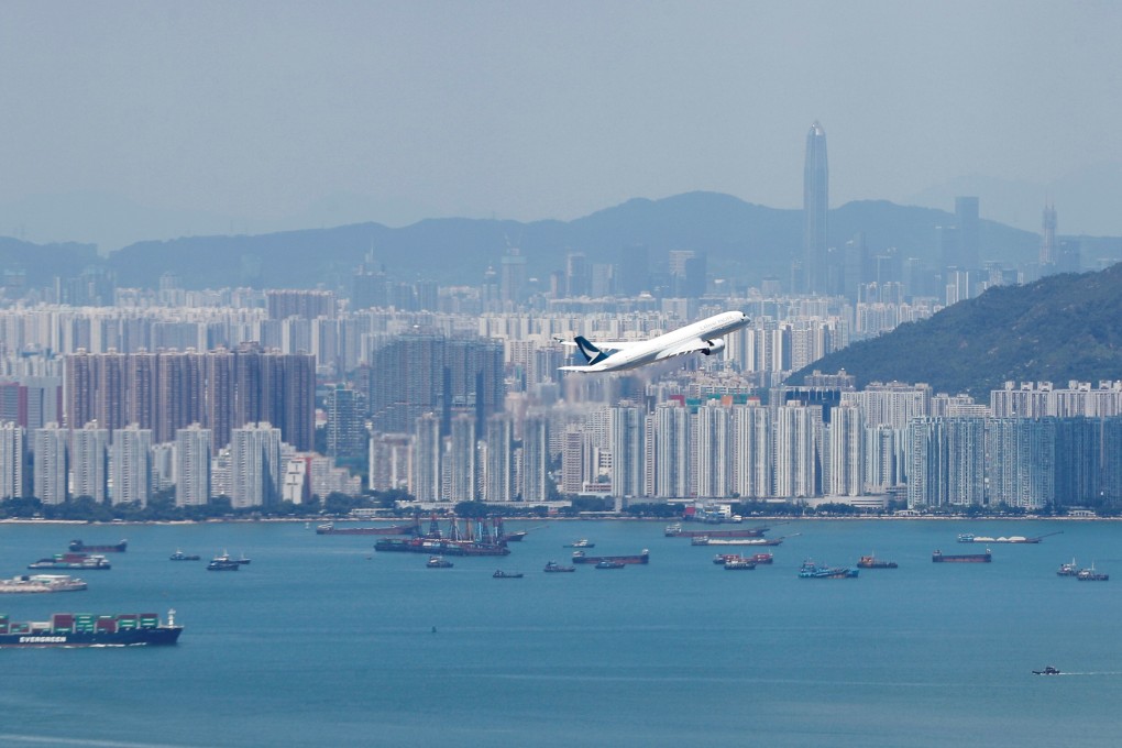 A flight takes off with Hong Kong in the background. Photo: Reuters
