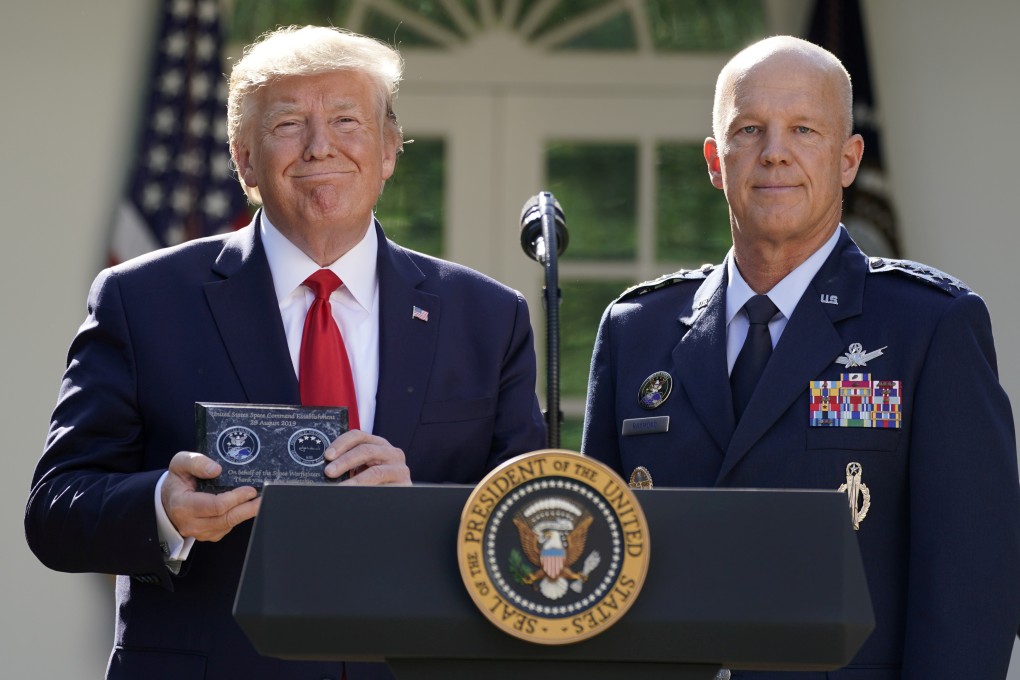 US President Donald Trump stands with General John Raymond, incoming US Space Command chief, during an event to officially launch the new wing of the US military. Photo: Reuters