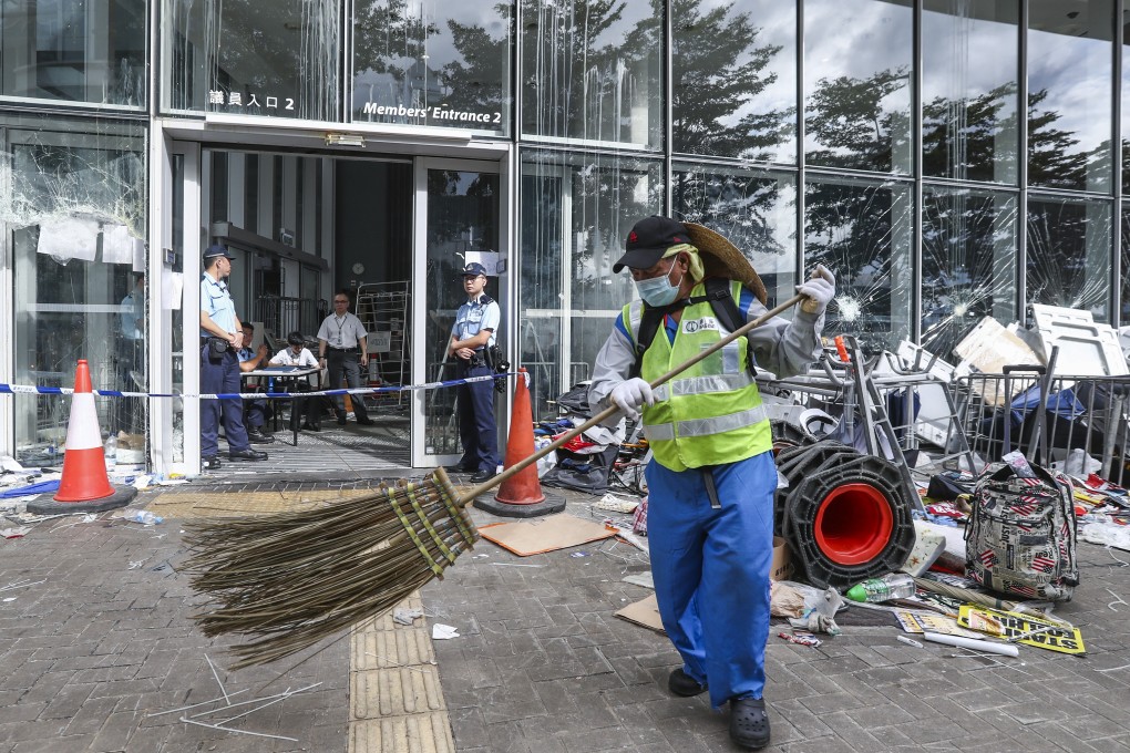 A worker begins the process of cleaning up after the Legislative Council complex was vandalised during an anti-government protest on July 1. Photo: Nora Tam