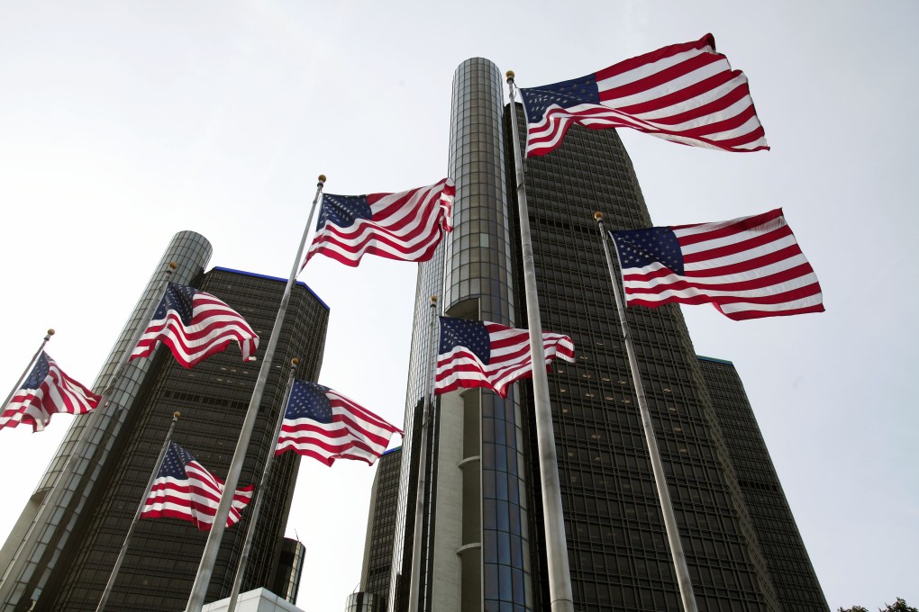 American flags wave outside the General Motors world headquarters building in Detroit, Michigan. Photo: AFP