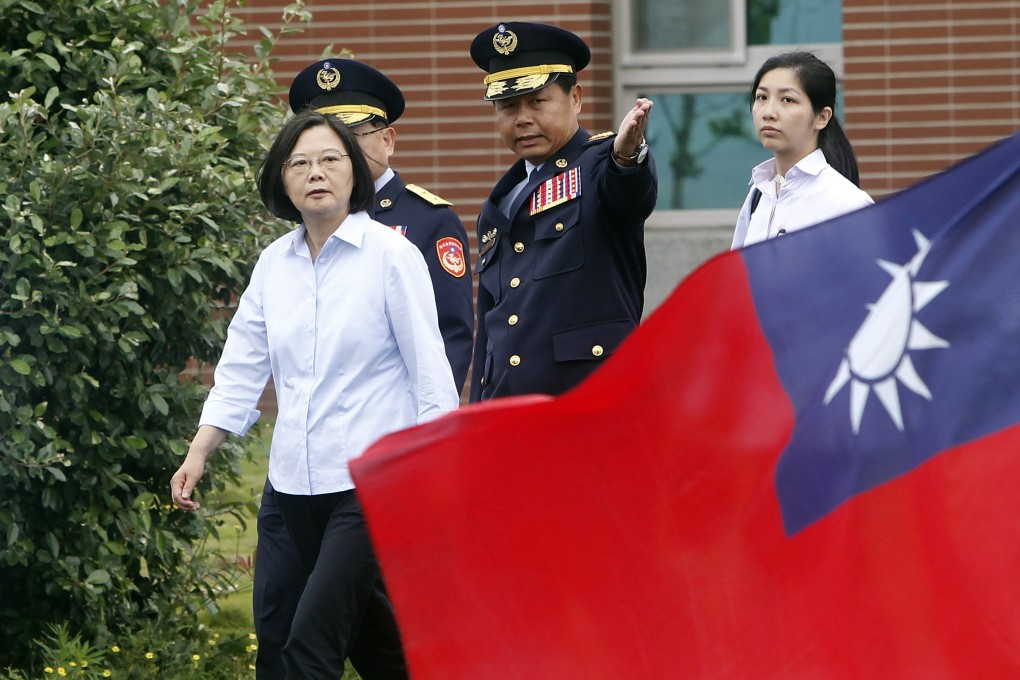Taiwanese President Tsai Ing-wen, left, walks past a Taiwan national flag during an offshore anti-terrorism drill outside Taipei harbor in New Taipei City, on August 15. Tsai has been vocal in her support of the demonstrations in Hong Kong against China’s deepening encroachment. Photo: AP