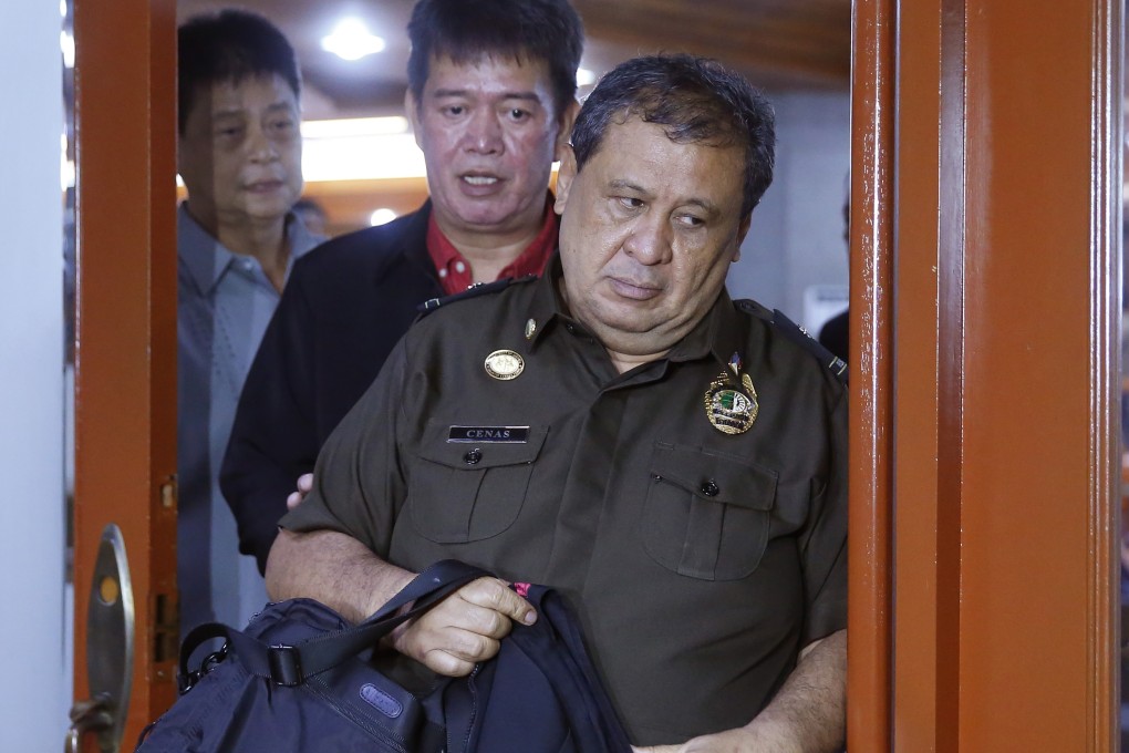 Ursicio Cenas is escorted to detention after he and two other Corrections officials were cited for contempt in a Senate probe. Photo: AP