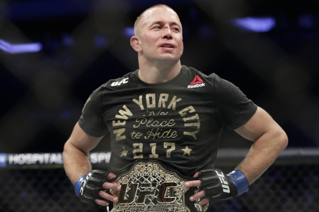 Georges St-Pierre says he is retired after beating Michael Bisping for the UFC middleweight title at UFC 217. Photo: AP