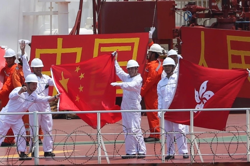 The crew of the Hong Kong-registered Gas Beryl tanker hold flags and banners as thanks to the PLA Navy escort. Photo: Weibo