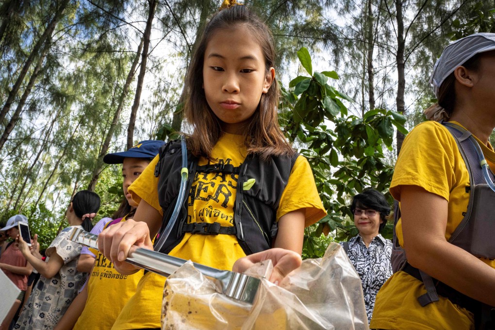 12-year-old Ralyn Satidtanasarn, known by her nickname Lilly, collects plastic waste during a clean-up by Thai NGO Trash Hero at the Khung Bang Kachao urban forest and beach in Bangkok. She paddles the city’s canals picking up plastic and other waste, sometimes skipping class to do so. Photo: Mladen Antonov/AFP