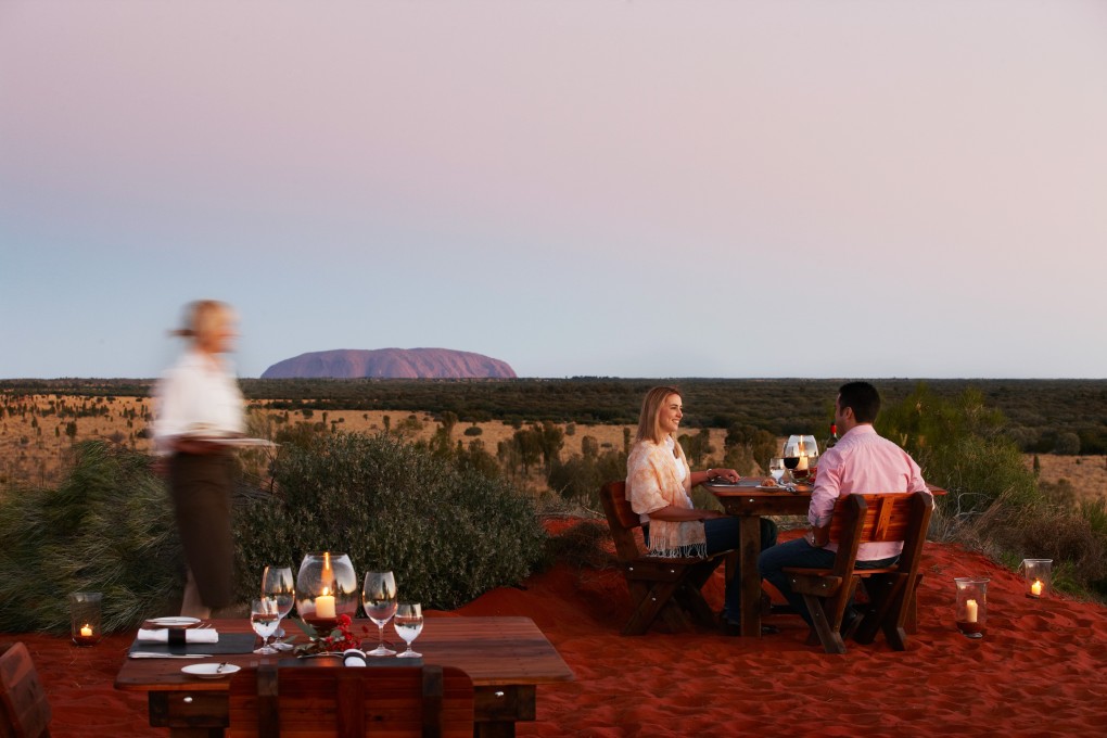 Dinner being served at Tali Wiru, with Uluru in the background. Photo: Tali Wiru
