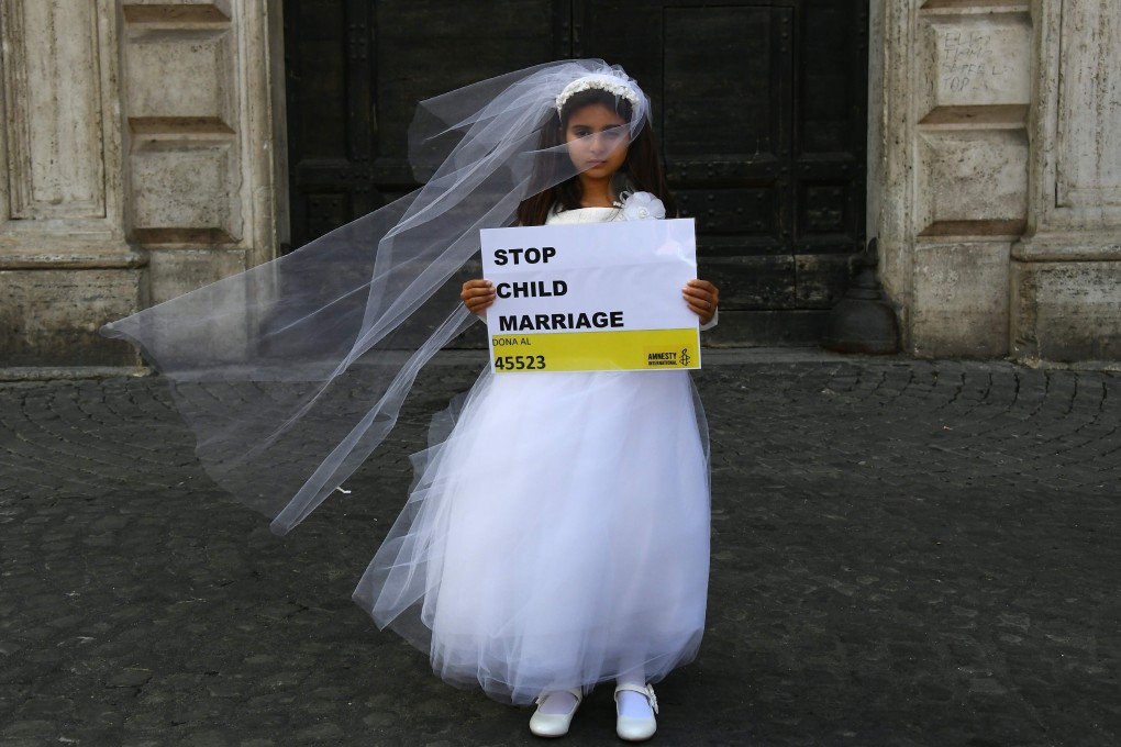 A 10-year-old actress dons a wedding gown at an event organised by Amnesty International to denounce child marriage. Photo: AFP