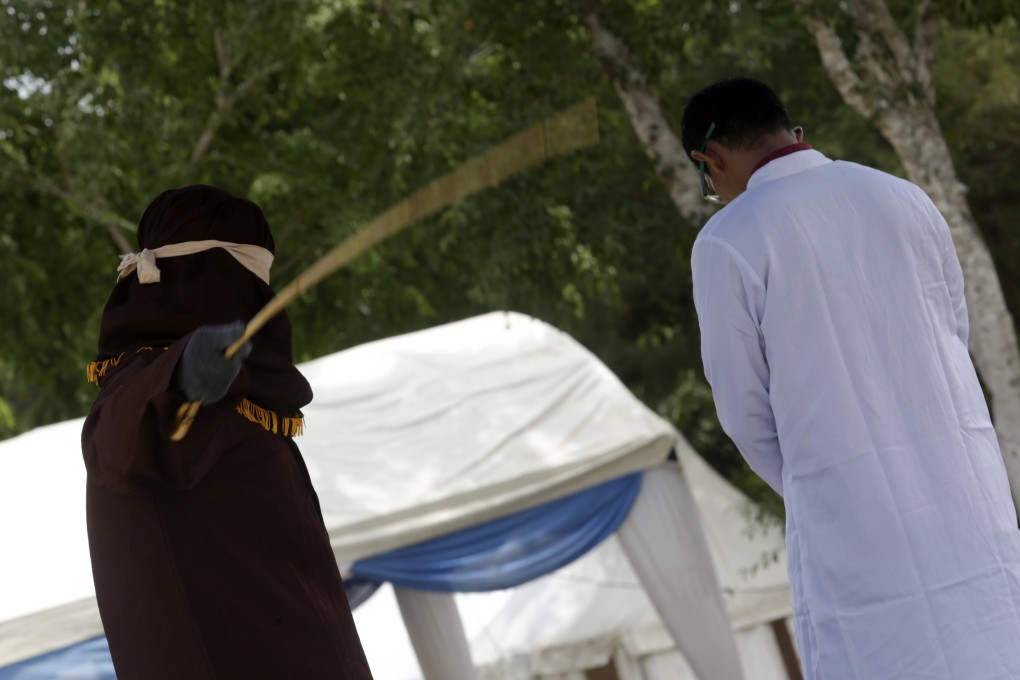 A man in Aceh is caned in public for having sex outside marriage in Banda Aceh. Photo: EPA-EFE