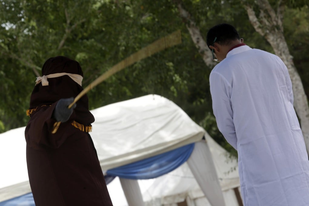 A man in Aceh is caned in public for having sex outside marriage in Banda Aceh. Photo: EPA-EFE