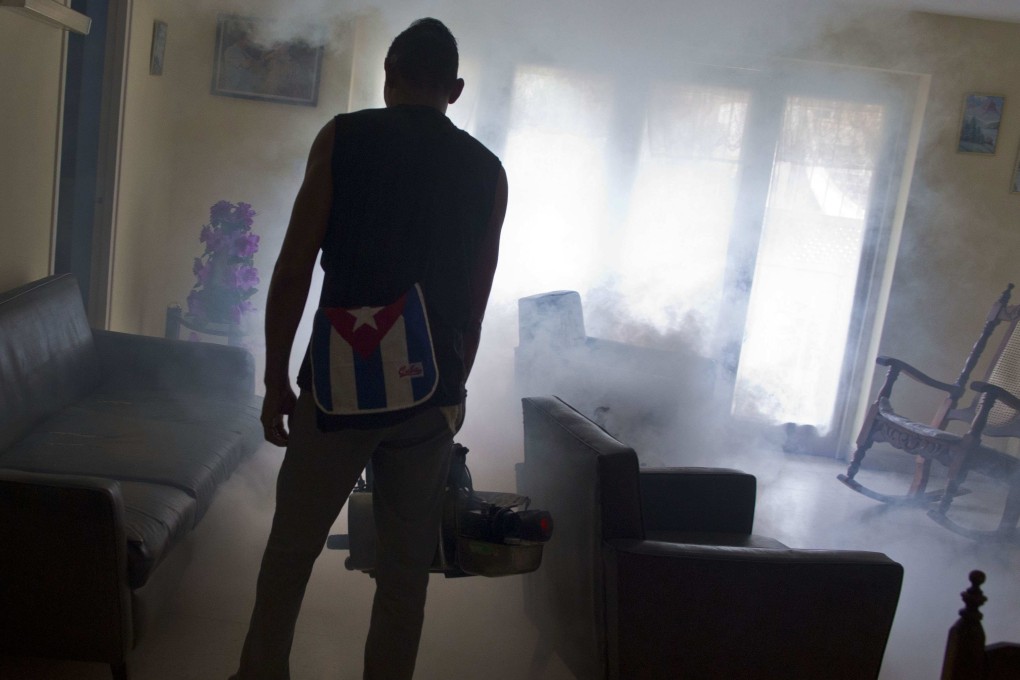 A government fumigator sprays a home for mosquitoes in Havana, Cuba, in August 2016. Photo: AP