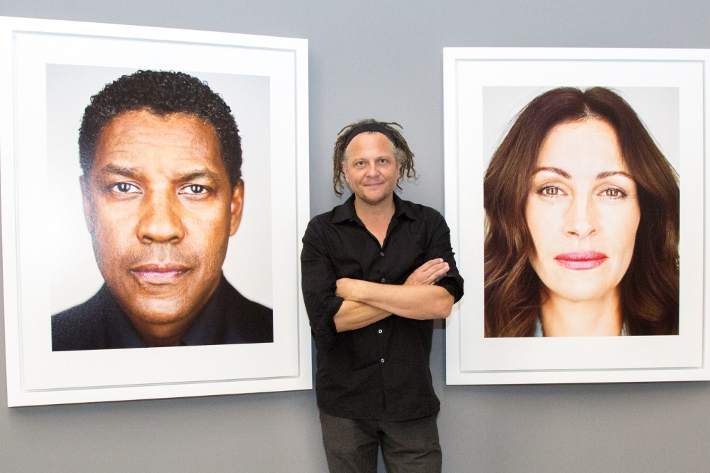 Martin Schoeller with photos of Denzel Washington and Julia Roberts at the Shanghai Centre of Photography. Photo: Shen Zhonghai
