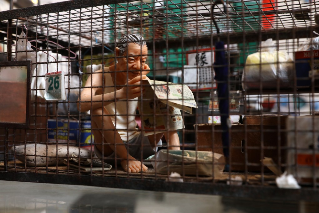 A miniature model of an elderly man in a “caged home” by artist Tai Yau-on illustrates the difficult living conditions some Hongkongers are forced to endure due to the city’s astronomical housing prices. Photo: K.Y. Cheng