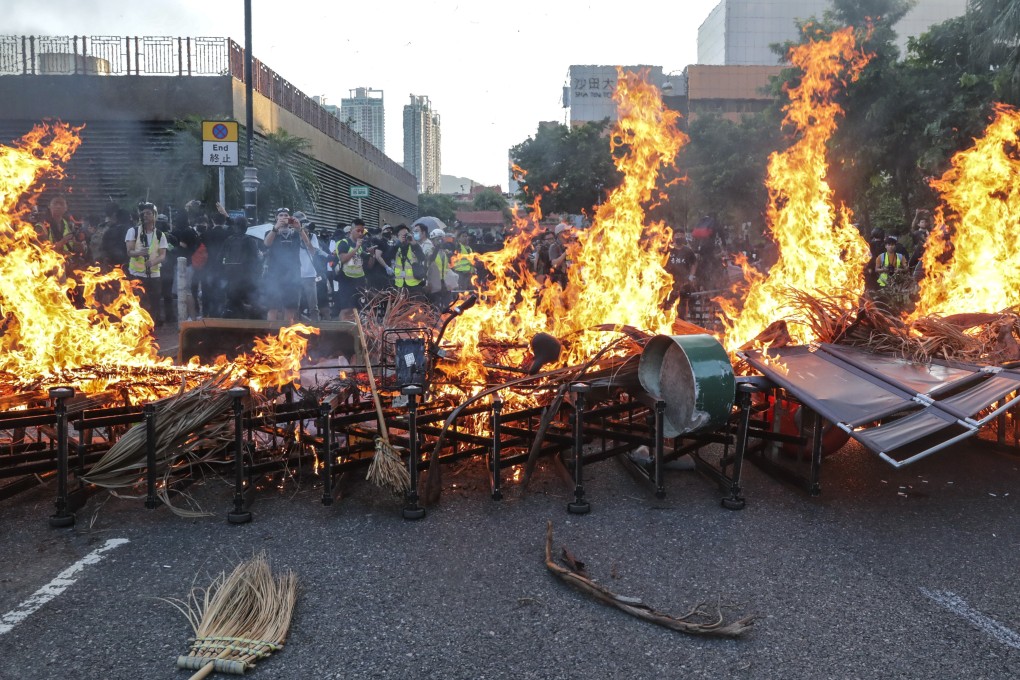Protesters set fire to a makeshift roadblock after vandalising and destroying MTR facilities at New Town Plaza and Sha Tin MTR station on September 22. Photo: Edmond So