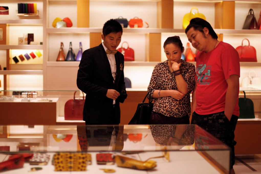A couple shop at a Louis Vuitton store in downtown Shanghai. Photo: Reuters