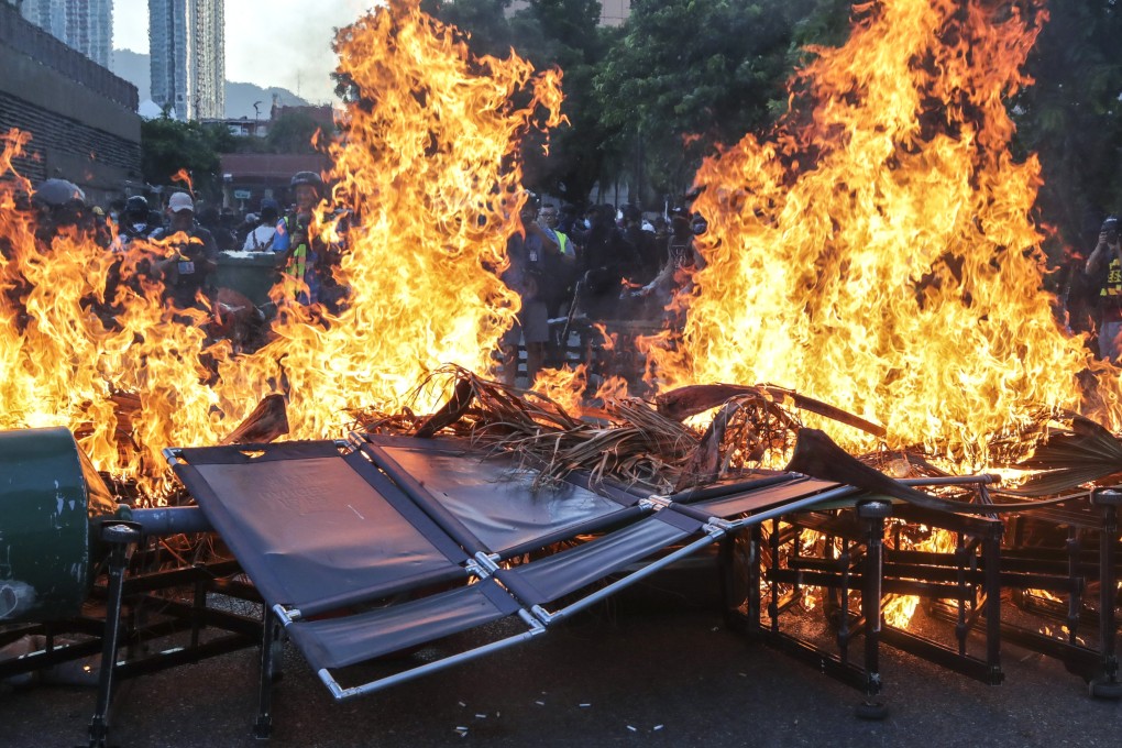 Protesters set fire to a roadblock after vandalising MTR facilities at New Town Plaza and Sha Tin stations. Photo: Edmond So