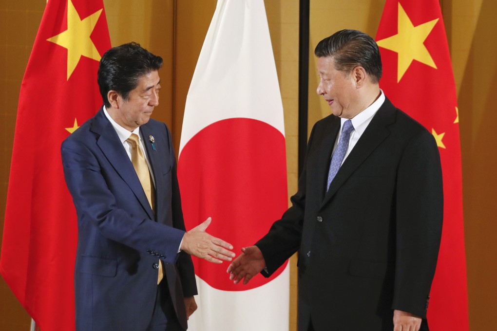 Chinese President Xi Jinping and Japanese Prime Minister Shinzo Abe shake hands at the start of their talks in Osaka on June 27. Japan-China relations will play a key role in whether China ultimately joins the Comprehensive and Progressive Agreement for a Trans-Pacific Partnership. Photo: EPA-EFE