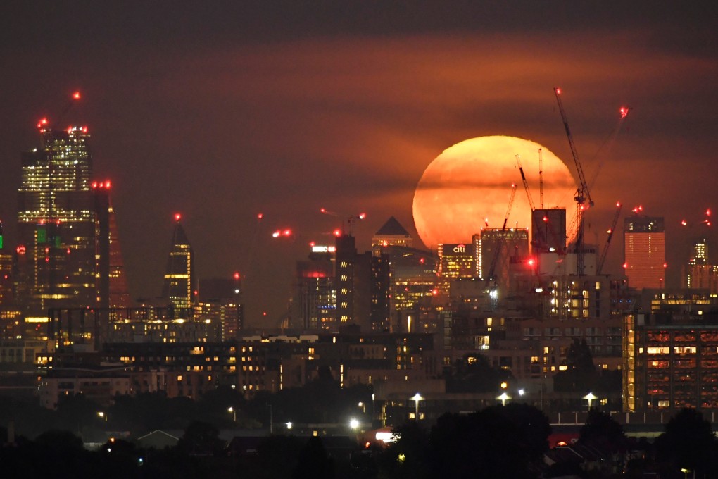 A harvest moon is seen rising behind London’s skyscrapers on September 14. Photo: Reuters
