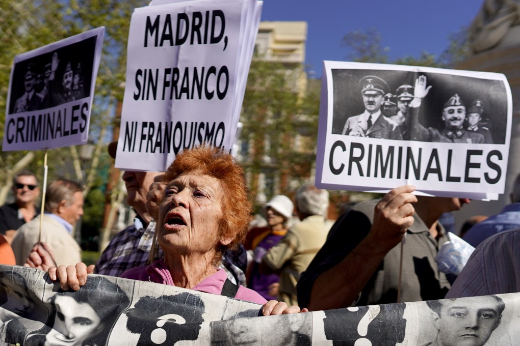 Protesters carry banners with a picture of Adolf Hitler and Francisco Franco during a protest outside Madrid's Supreme Court on Tuesday. Photo: Reuters