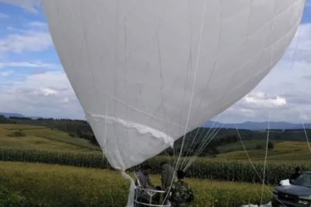 Two men land safely after drifting for more than 10km in a hydrogen balloon they were using to pick pine cones in China’s Changbai mountains. Photo: Weibo