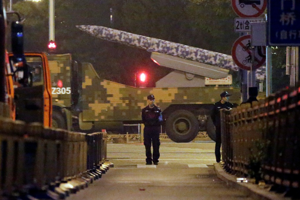 A military vehicle passes along a street in central Beijing on Saturday during a rehearsal for the parade on October 1. Photo: Reuters
