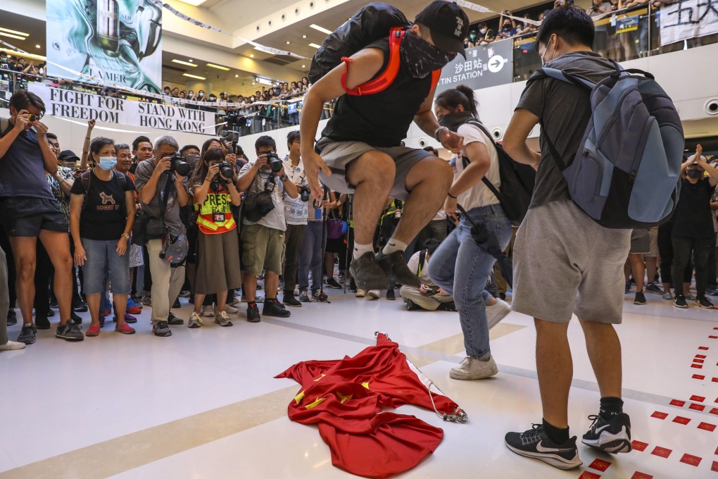Anyone who desecrates the flag or emblem by publicly and wilfully burning, mutilating, scrawling on, defiling or trampling on it is liable to three years’ imprisonment. Photo: Nora Tam