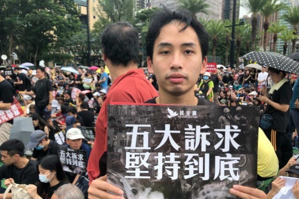 A protester, who supports non-violent action, holds a sign saying, “Holding out till the end for the five demands” at a rally on August 18. Photo: Handout