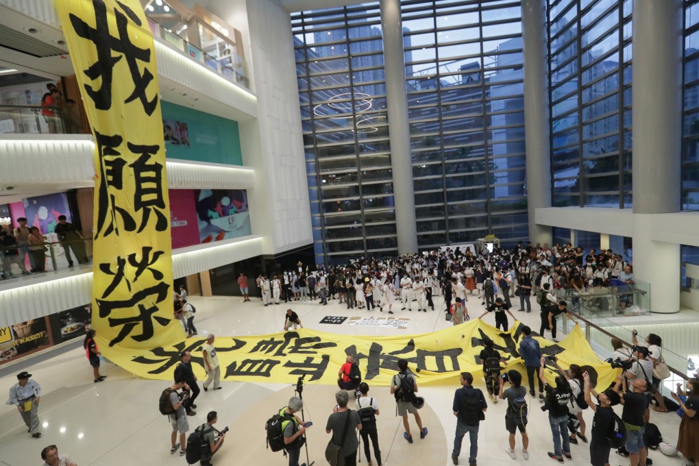 A large protest banner is unfurled in the Lok Fu Place mall on Monday. SCMP: Edmond So