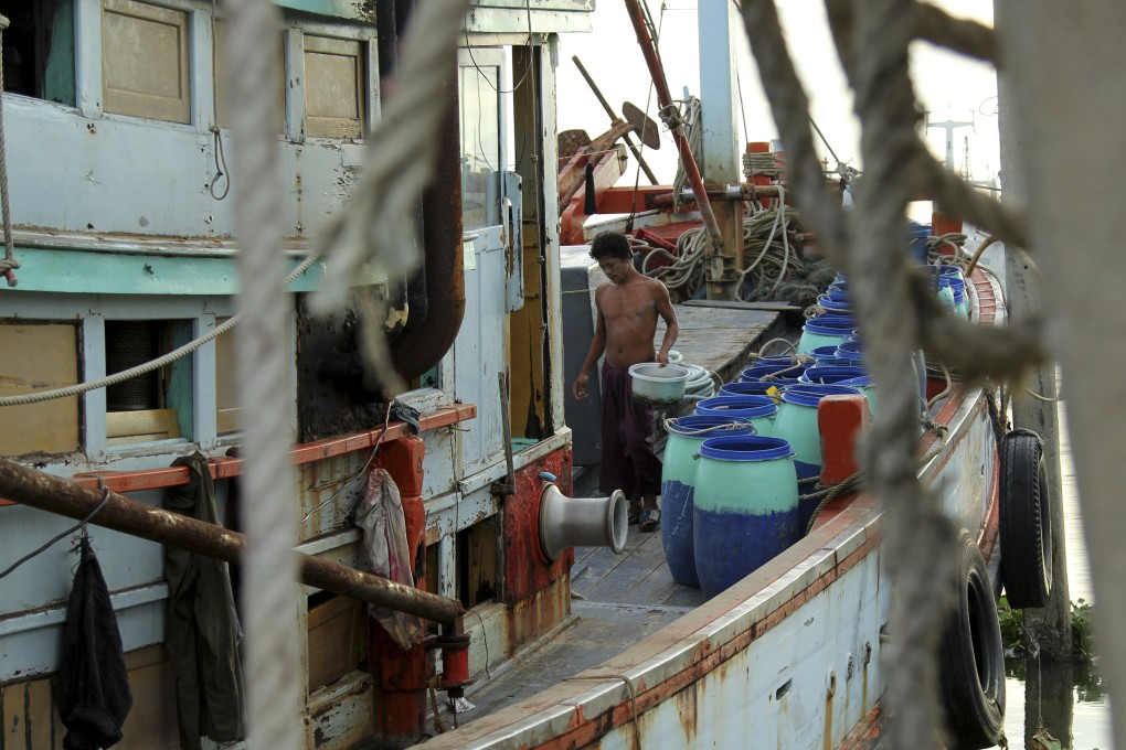 A Myanmese migrant cleans a fishing vessel in the port of Mahachai, one of the main hubs of the Thai fishing industry, a sector that has been linked to human trafficking and slave-like conditions. Photo: Laura Villadiego