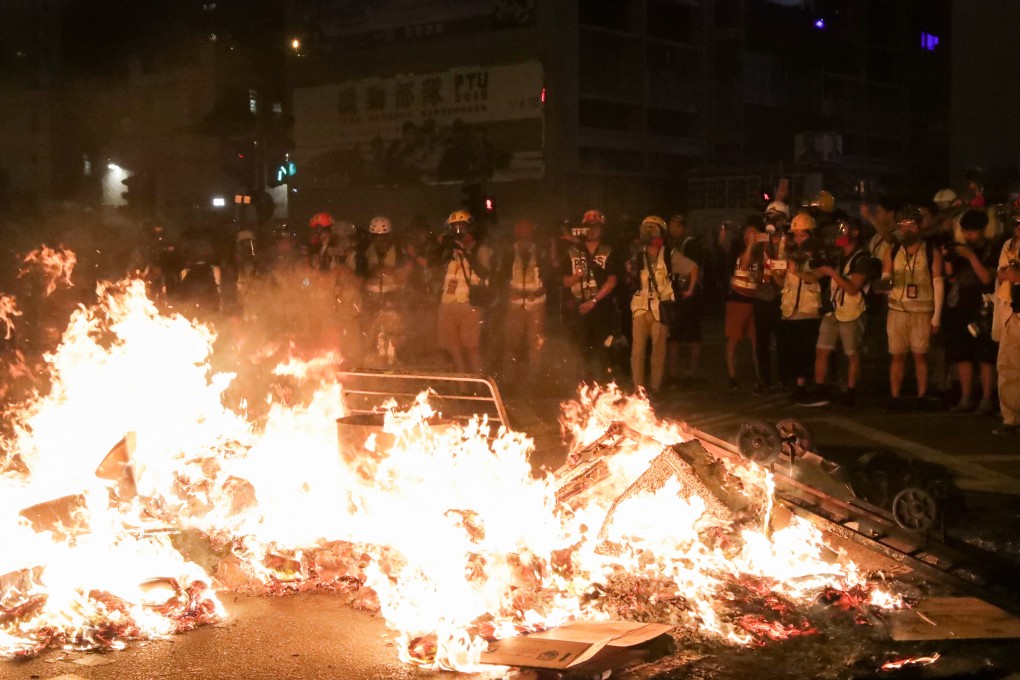Anti-government protesters start a fire on Nathan Road near Mong Kok Police Station on September 22. Photo: Edmond So