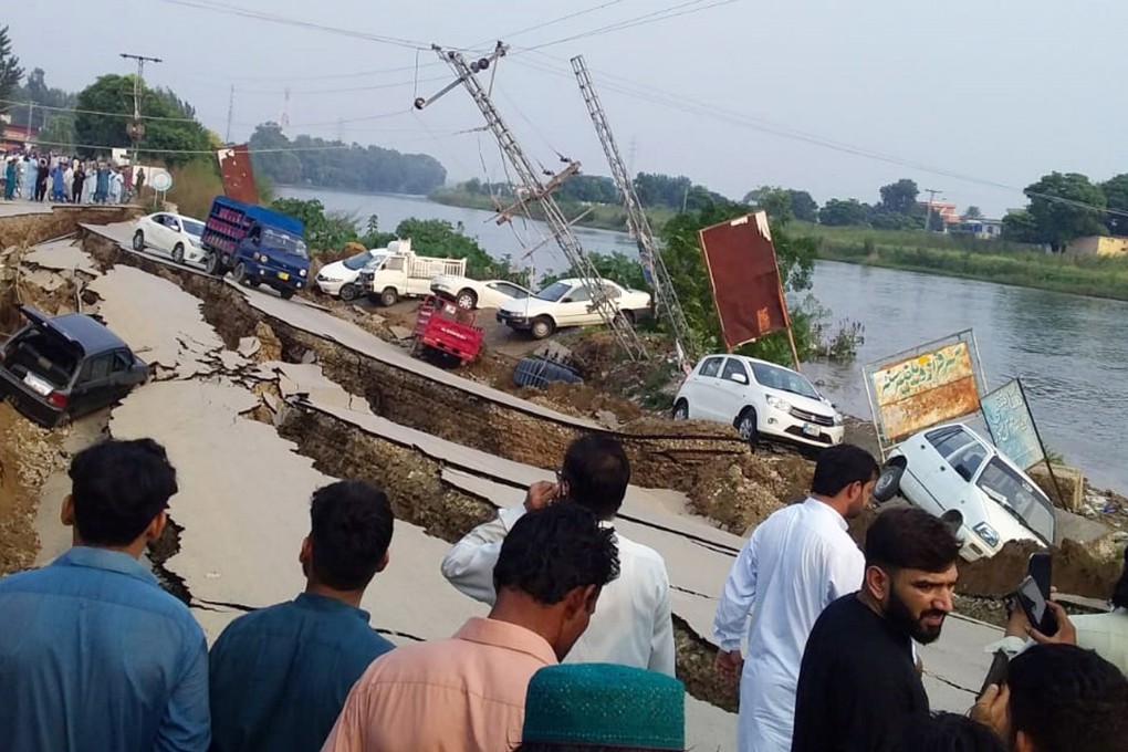 People gather near a damaged road after an earthquake in Mirpur, Pakistan. Photo: Reuters