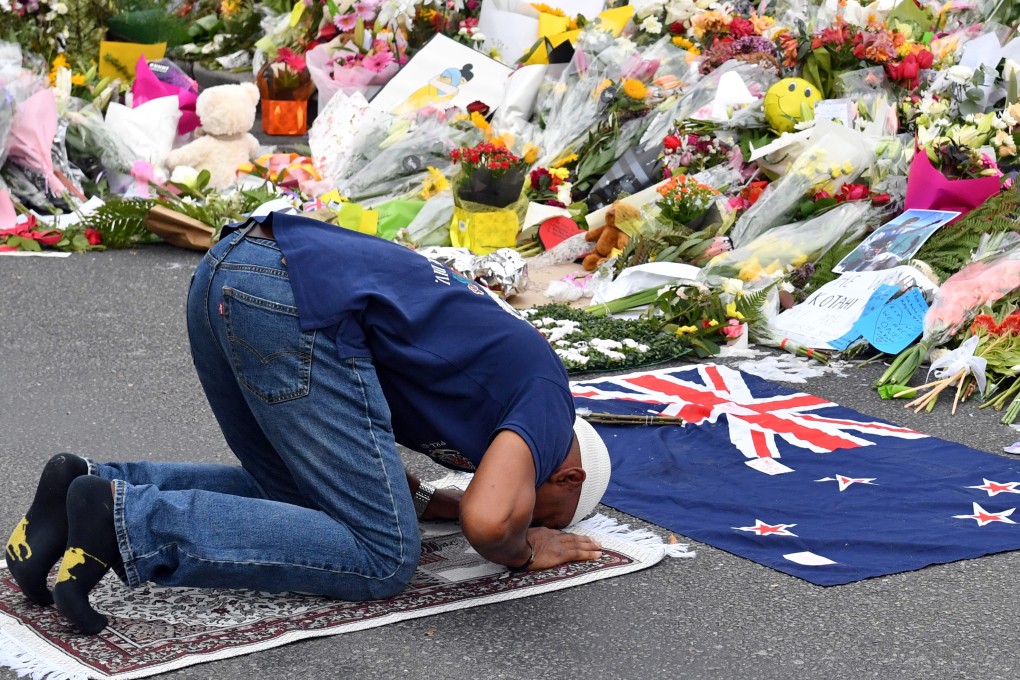 A Muslim worshipper prays at a makeshift memorial at the Al Noor Mosque in Christchurch. Photo: EPA