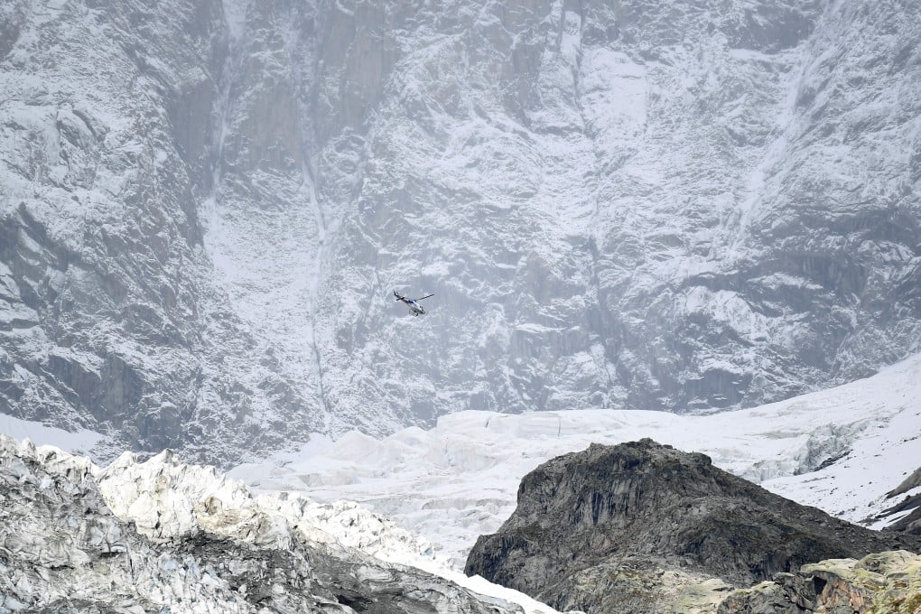 A helicopter flies over a segment of the Planpincieux glacier on the Italian side of the Mont Blanc massif area. Photo: Reuters