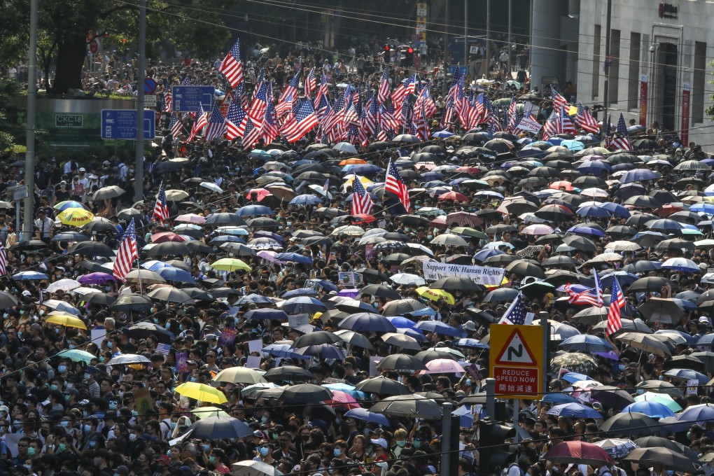 American flags fly as protesters take part in a march from Chater Garden in the Central district of Hong Kong to the consulate central of the United States. Photo: KY Cheng
