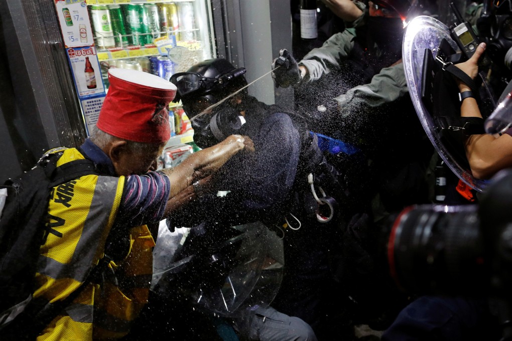 An anti-government protester is pepper-sprayed during a clash with the police near Yuen Long MTR station on September 21. Photo: Reuters