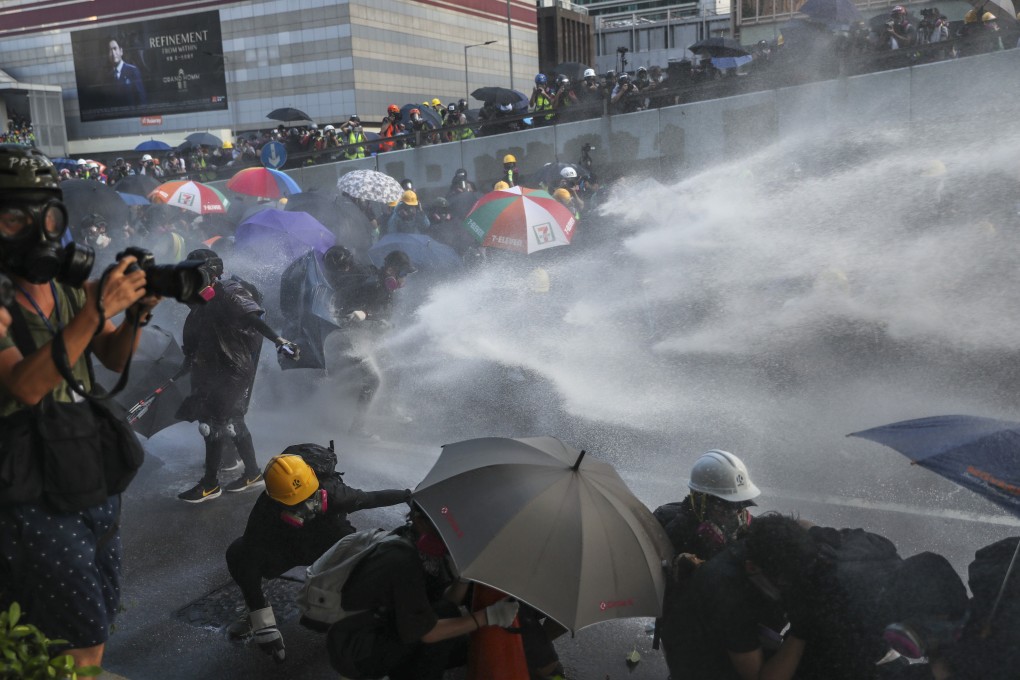 Riot police fire water cannon at demonstrators in Hong Kong earlier this month. Anti-government protests have gripped the city since early June. Photo: Sam Tsang