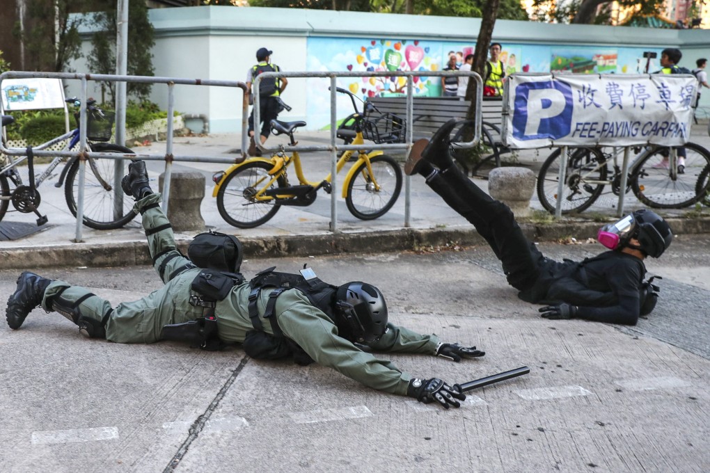 A riot police officer stumbles as he attempts to arrest an anti-government protester in Sha Tin, Hong Kong, on September 22. Protesters and police have a lot more in common than Beijing and the police. Photo: Sam Tsang