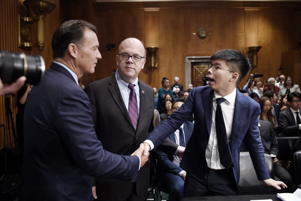 Pro-democracy activist Joshua Wong (right) shakes hands with US Representative Tom Suozzi as Jim McGovern, chairman of the Congressional-Executive Commission on China, looks on, before a hearing on Hong Kong’s pro-democracy movement on September 17 in Washington, DC. Photo: AFP