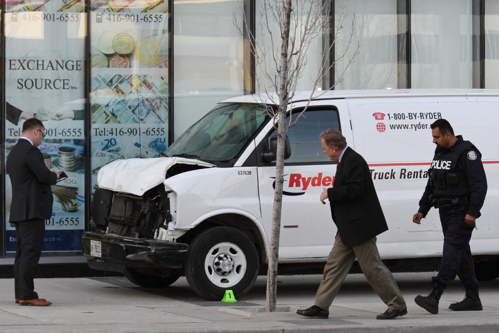 Investigators view the damaged van in Toronto. Photo: Reuters