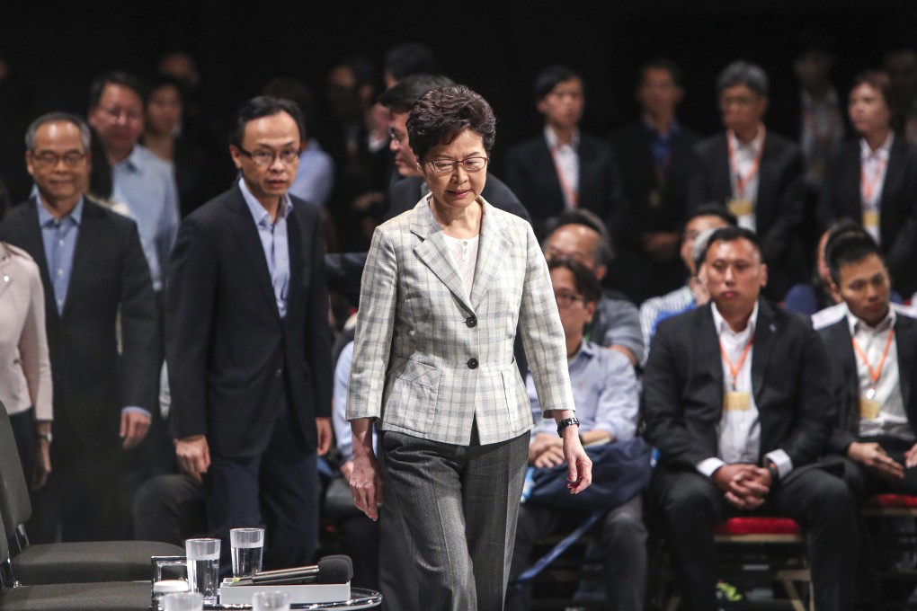 Chief Executive Carrie Lam (centre) arrives to meet the public during a dialogue session at Queen Elizabeth Stadium. Photo: Winson Wong