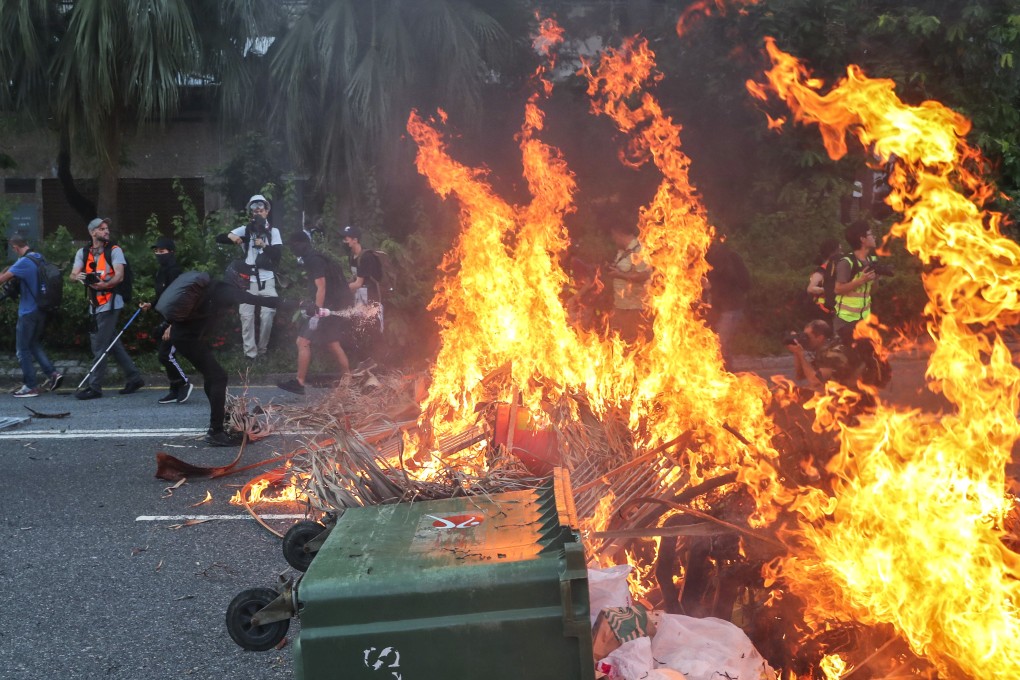 Protesters set fire at a roadblock on Sunday after wreaking havoc at two Hong Kong MTR stations. US legislation aimed at supporting democratic freedoms in the city targets media outlets affiliated with Beijing. Photo: Sam Tsang