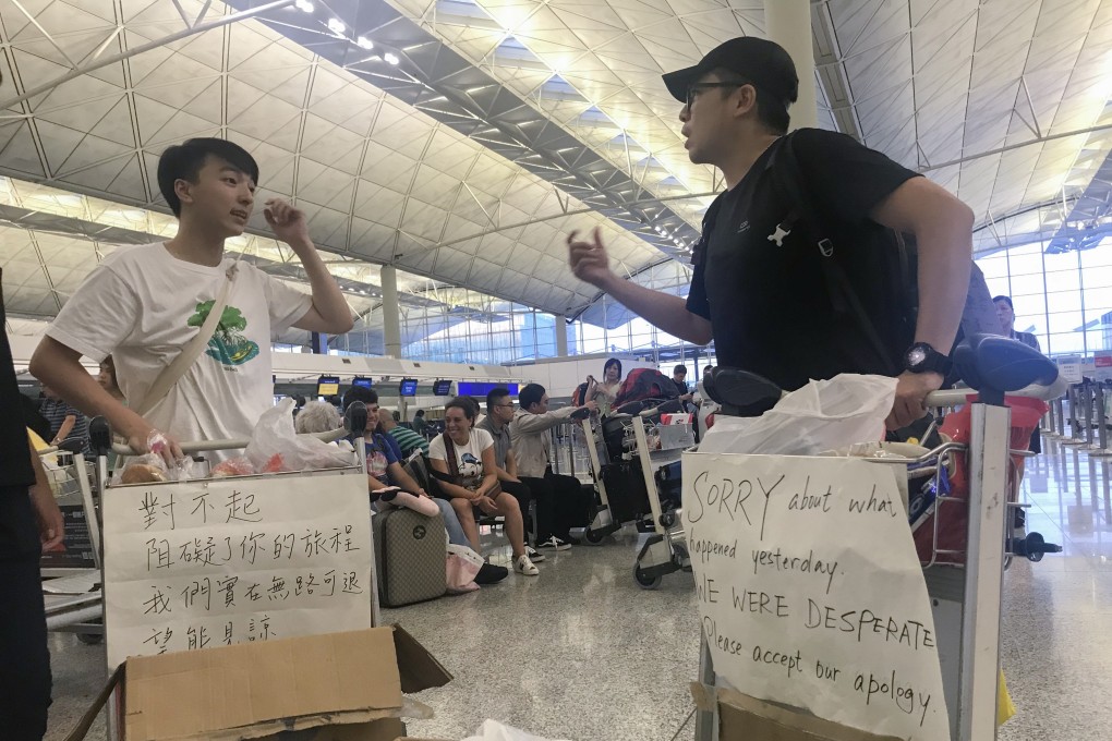 Protesters distribute food and water to passengers at Hong Kong airport on August 14 and apologise for the disruption they caused the day before. Photo: Kimmy Chung